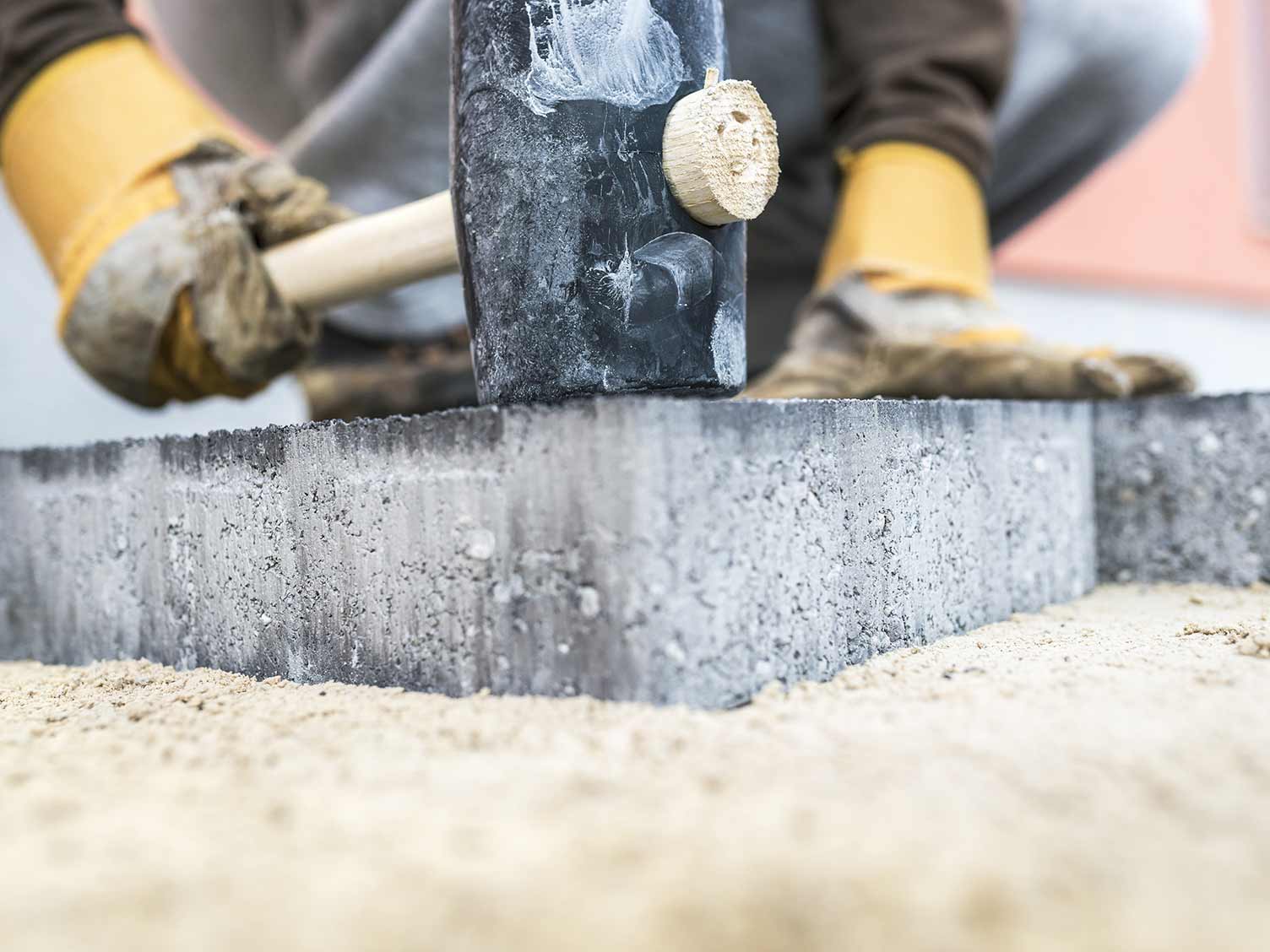 UK_tapping-down-paving-with-mallet.jpg Tapping down paving slabs with a mallet