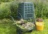 Green Dalek bin in front of purple salvia