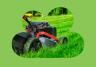 Red lawn mower being pushed over a green lawn