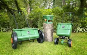 Miracle-Gro lawn spreader range displayed on a lawn.