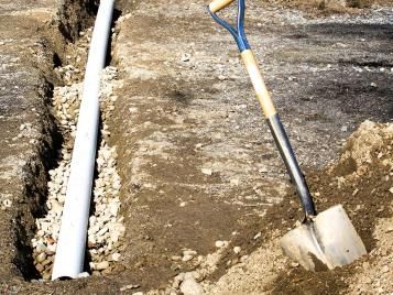 Digging a French drain in a garden