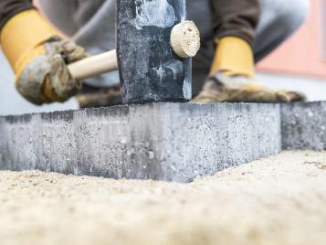 Tapping down paving slabs with a mallet