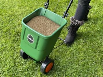 Miracle-Gro Rotary Spreader applying grass seed